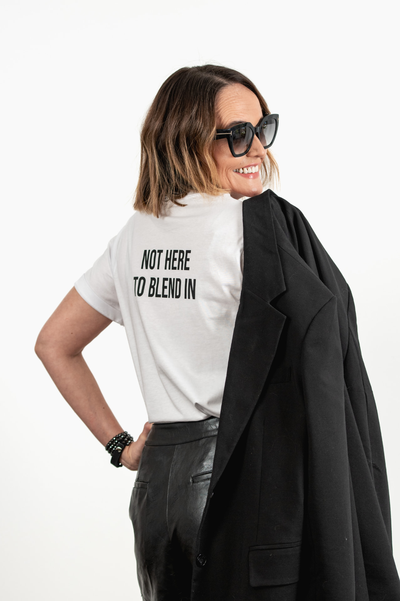 Claire wearing a T-shirt that reads 'not here to blend in.'